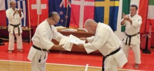 Peter Larsen receiving the Shibu Certificate from Kaicho Akamine Hiroshi